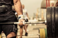 Closeup portrait of professional bodybuilder workout with barbell outdoors