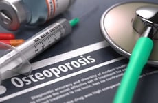 Diagnosis - Osteoporosis. Medical Concept with Blurred Text, Stethoscope, Pills and Syringe on Grey Background. Selective Focus.