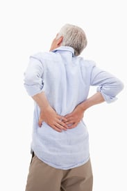 Portrait of a man having a back pain against a white background