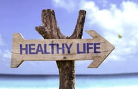 Healthy Life wooden sign with a beach on background-1