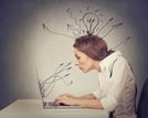 Young business woman working typing on computer in her office