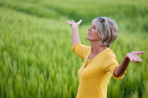 mature woman with outstretched arms in nature-1